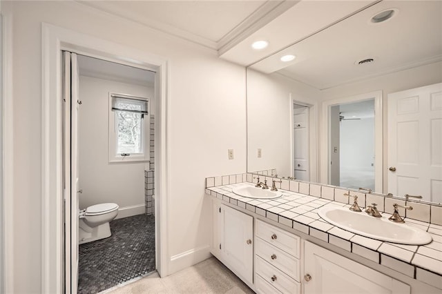 bathroom with a sink, baseboards, toilet, and ornamental molding