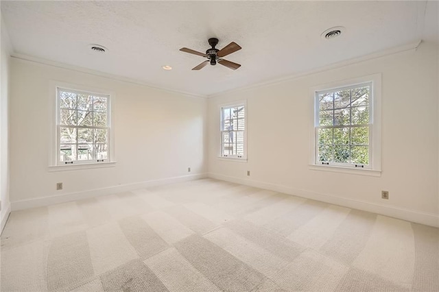 unfurnished room with crown molding, light colored carpet, and visible vents