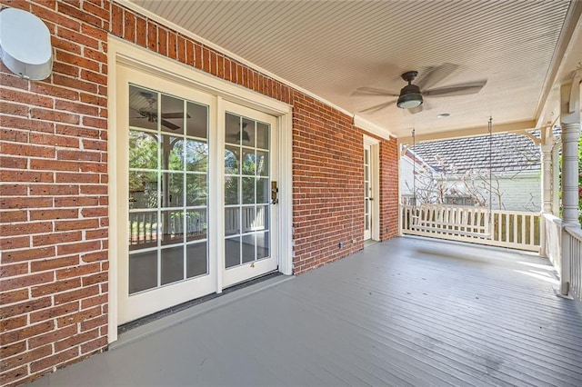 wooden deck featuring a porch and a ceiling fan