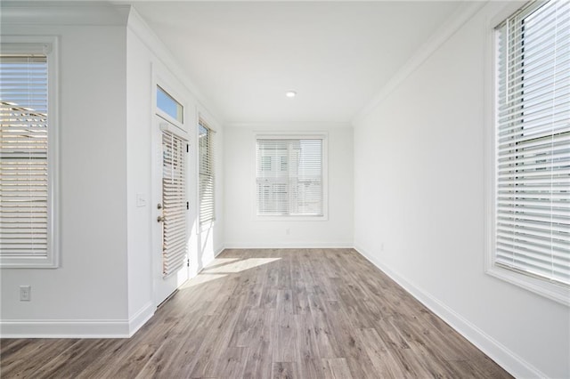 hall with crown molding and hardwood / wood-style floors