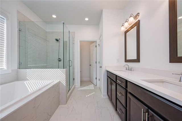 bathroom featuring vanity and shower with separate bathtub