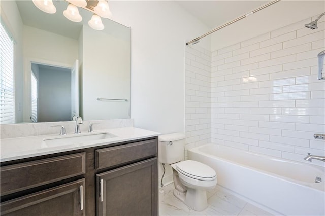 full bathroom with vanity, toilet, and tiled shower / bath