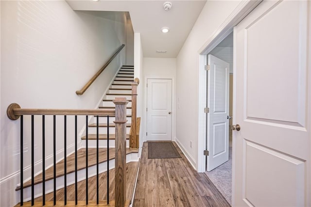 hall with wood-type flooring