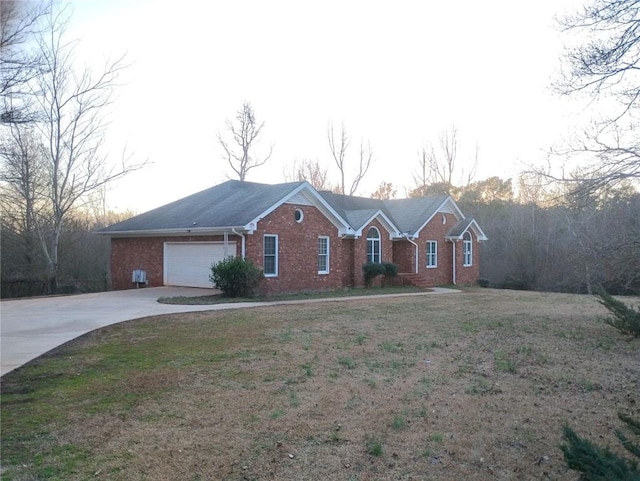 ranch-style house with a garage and a front yard