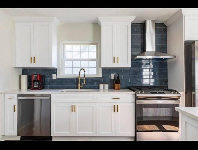 205 Maple St, Atlanta, GA 30354 - kitchen with appliances with stainless steel finishes, wall chimney exhaust hood, tasteful backsplash, and white cabinetry