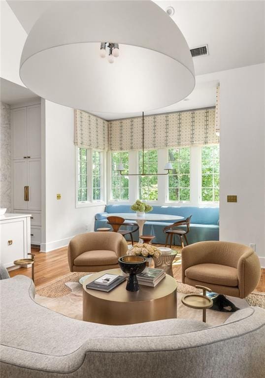 living room featuring a healthy amount of sunlight and light hardwood / wood-style flooring