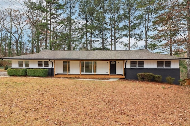 ranch-style house featuring a porch and a front lawn