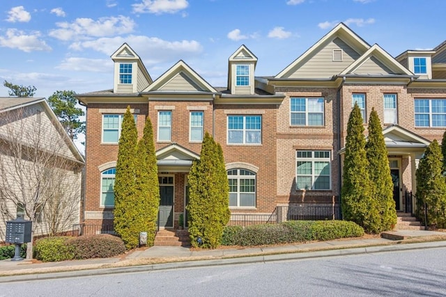 townhome / multi-family property featuring brick siding