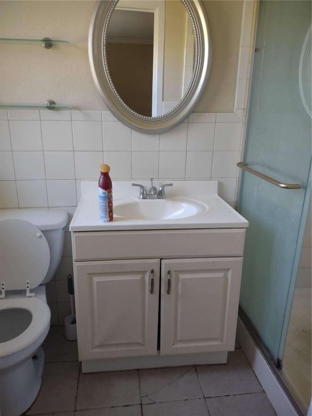 bathroom featuring tasteful backsplash, vanity, tile walls, and toilet