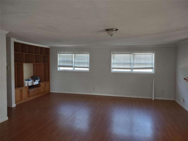 unfurnished room featuring crown molding and dark hardwood / wood-style floors