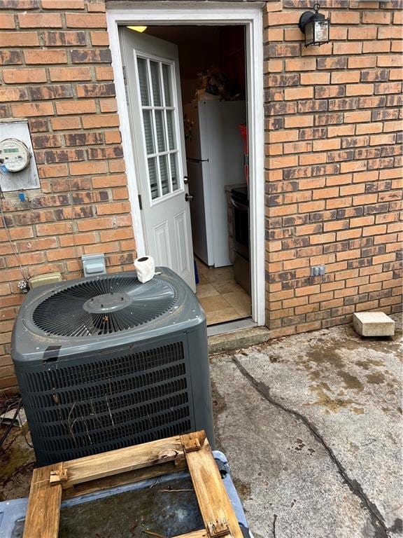 4701 Flat Shoals Rd Unit 65A, Union City, GA 30291 - exterior view of central AC, brick siding, electric meter, and freestanding refrigerator