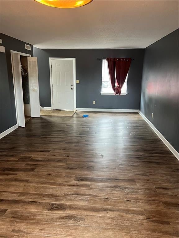 4701 Flat Shoals Rd Unit 65A, Union City, GA 30291 - unfurnished living room featuring baseboards and wood finished floors