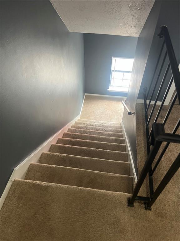 4701 Flat Shoals Rd Unit 65A, Union City, GA 30291 - stairs featuring carpet flooring, baseboards, and a textured ceiling