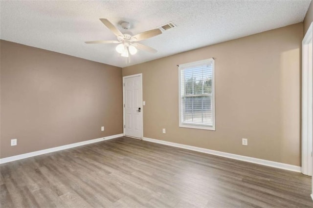 unfurnished room featuring hardwood / wood-style flooring, a textured ceiling, and ceiling fan