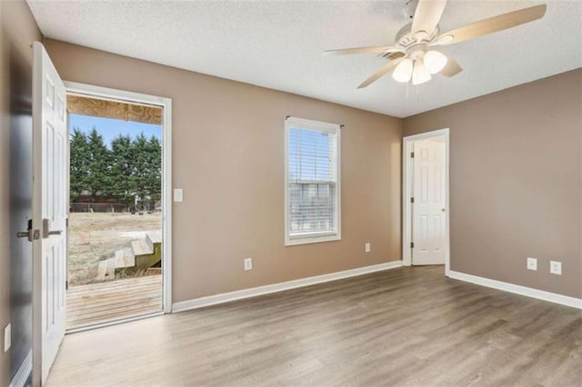 unfurnished room featuring ceiling fan, a textured ceiling, and light hardwood / wood-style flooring