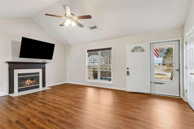 unfurnished living room with ceiling fan, hardwood / wood-style floors, and lofted ceiling