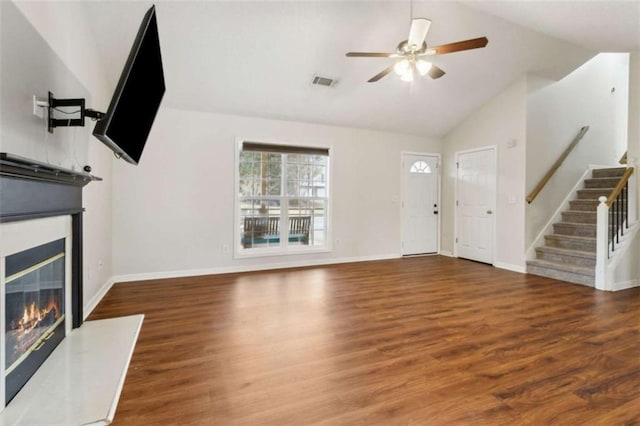 unfurnished living room with vaulted ceiling, ceiling fan, and dark hardwood / wood-style flooring