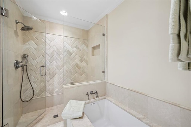 bathroom featuring crown molding and shower with separate bathtub