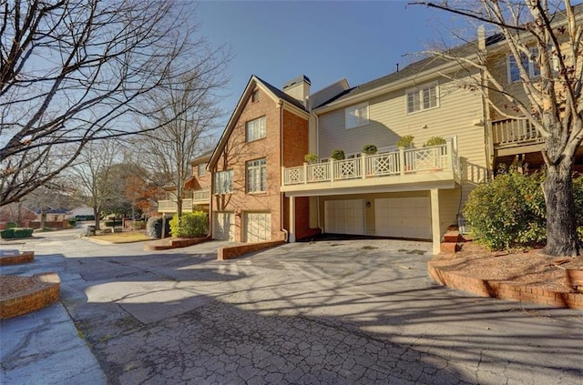 exterior space featuring a garage and a balcony