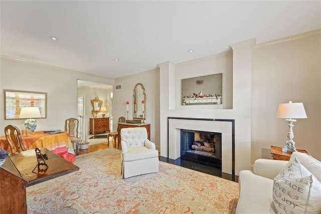 living room featuring hardwood / wood-style floors and crown molding