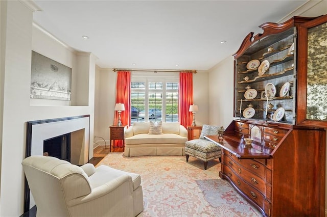 living room featuring crown molding and light hardwood / wood-style flooring