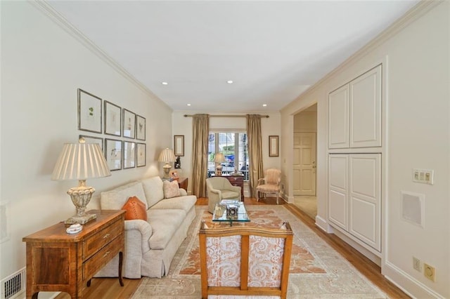 living room with crown molding and light wood-type flooring