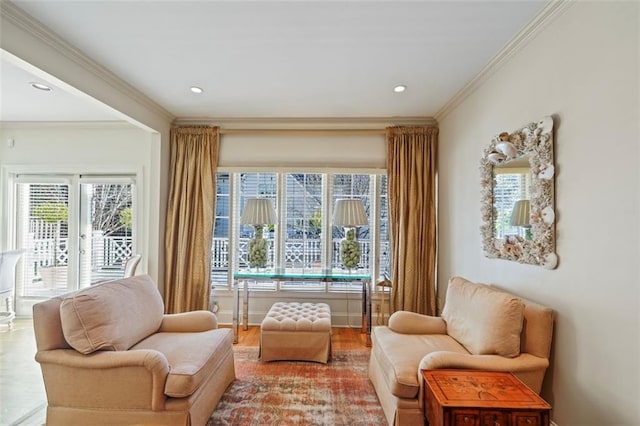 living area with hardwood / wood-style flooring and ornamental molding