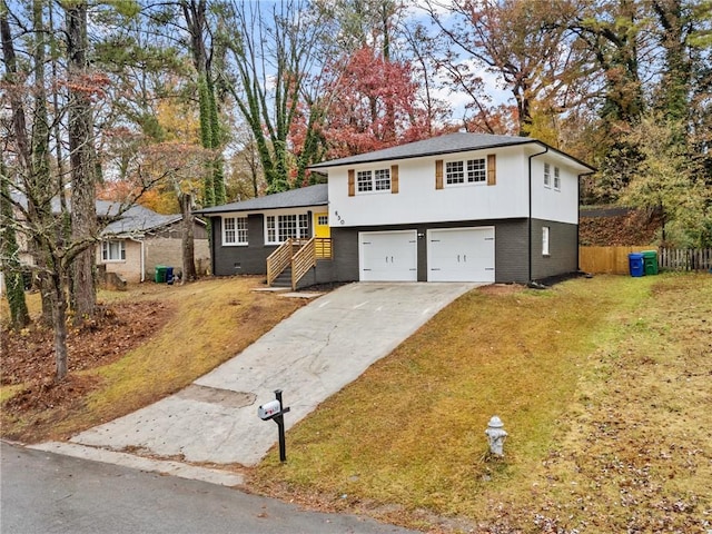 split level home with a garage and a front lawn