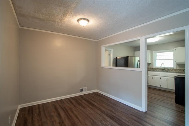 2308 Sheryl Dr, Decatur, GA 30032 - unfurnished room featuring dark wood-style flooring, ornamental molding, a textured ceiling, a sink, and baseboards