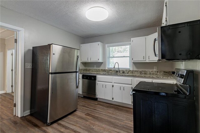 2308 Sheryl Dr, Decatur, GA 30032 - kitchen featuring appliances with stainless steel finishes, a textured ceiling, a sink, dark wood-style floors, and white cabinets