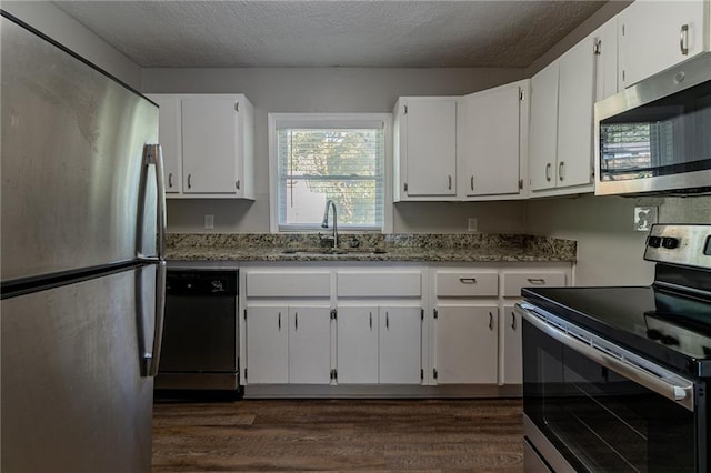2308 Sheryl Dr, Decatur, GA 30032 - kitchen featuring stainless steel appliances, a sink, light stone counters, dark wood-style flooring, and healthy amount of natural light