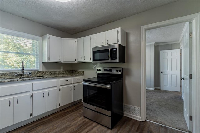 2308 Sheryl Dr, Decatur, GA 30032 - kitchen with stainless steel appliances, a textured ceiling, a sink, white cabinets, and dark wood-style flooring