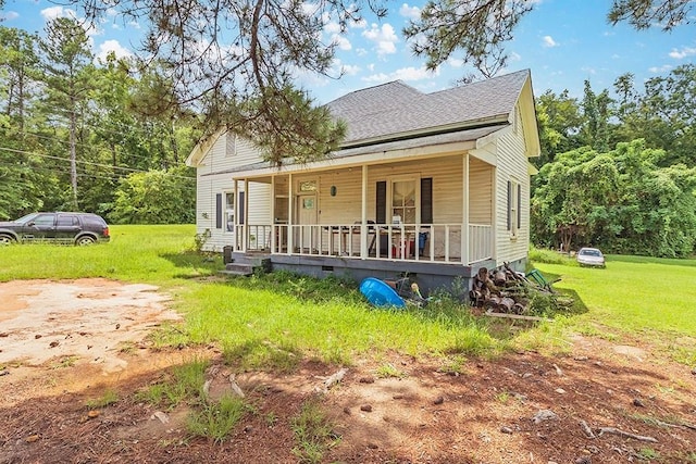 view of front of home featuring a shingled roof, a front yard, covered porch, and crawl space