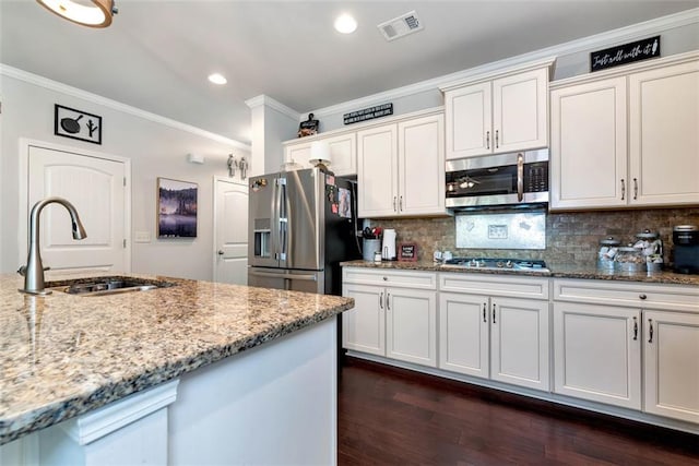 6628 Rivergreen Rd, Flowery Branch, GA 30542 - kitchen featuring appliances with stainless steel finishes, a sink, crown molding, light stone counters, and tasteful backsplash