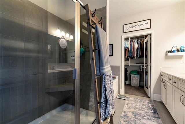 6628 Rivergreen Rd, Flowery Branch, GA 30542 - bathroom with vanity, a shower stall, and a spacious closet