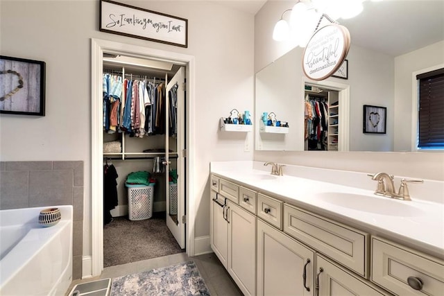 6628 Rivergreen Rd, Flowery Branch, GA 30542 - bathroom featuring double vanity, a walk in closet, a bath, and tile patterned flooring
