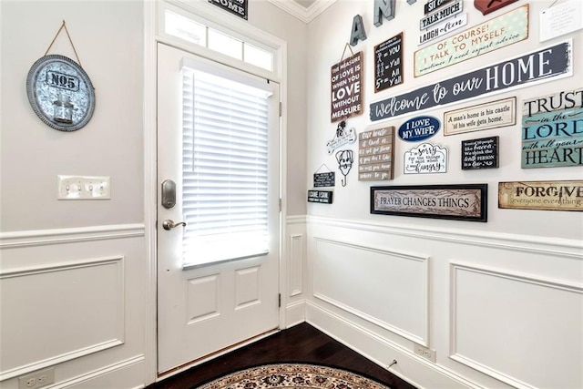 6628 Rivergreen Rd, Flowery Branch, GA 30542 - entryway featuring crown molding, a wainscoted wall, dark wood-type flooring, and a decorative wall