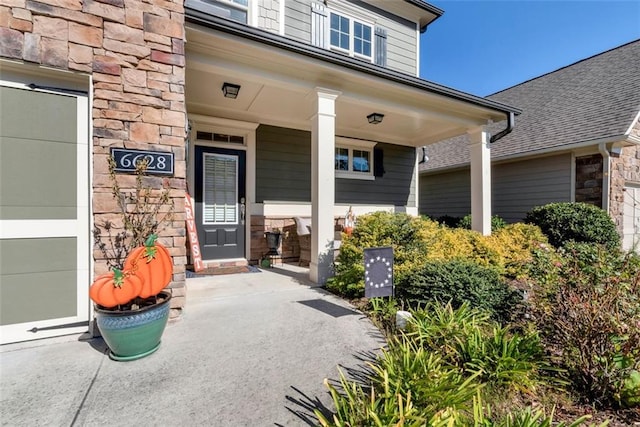 6628 Rivergreen Rd, Flowery Branch, GA 30542 - entrance to property featuring stone siding, a porch, and roof with shingles