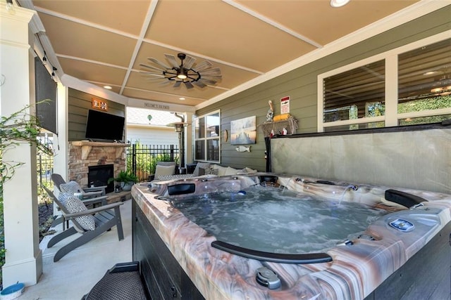 6628 Rivergreen Rd, Flowery Branch, GA 30542 - view of patio / terrace with an outdoor stone fireplace, a hot tub, and ceiling fan