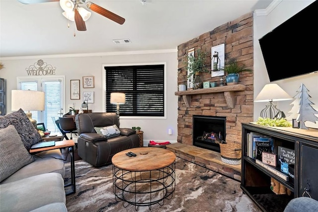 6628 Rivergreen Rd, Flowery Branch, GA 30542 - living room featuring crown molding, a ceiling fan, and a stone fireplace