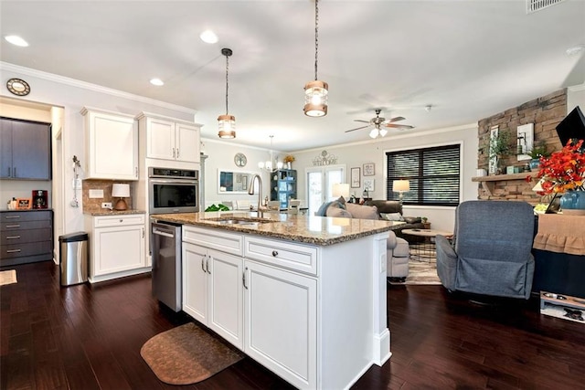 6628 Rivergreen Rd, Flowery Branch, GA 30542 - kitchen with stainless steel appliances, a sink, open floor plan, crown molding, and light stone counters