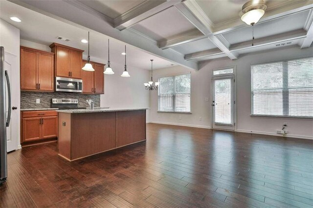 kitchen with decorative light fixtures, stainless steel appliances, a center island with sink, dark hardwood / wood-style floors, and beam ceiling