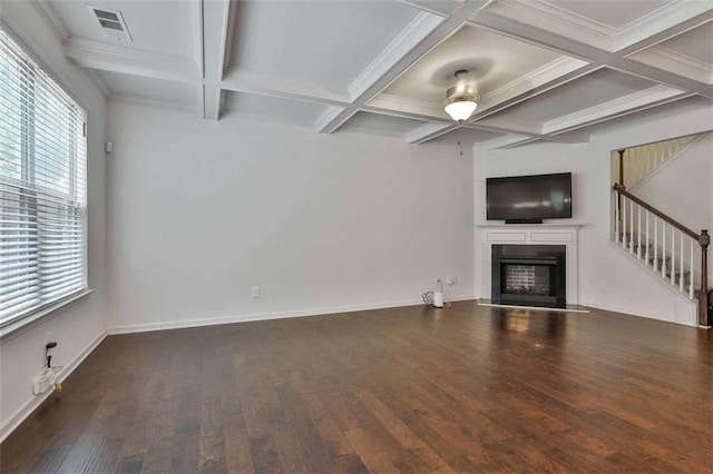 unfurnished living room featuring coffered ceiling, ceiling fan, a wealth of natural light, and dark hardwood / wood-style floors