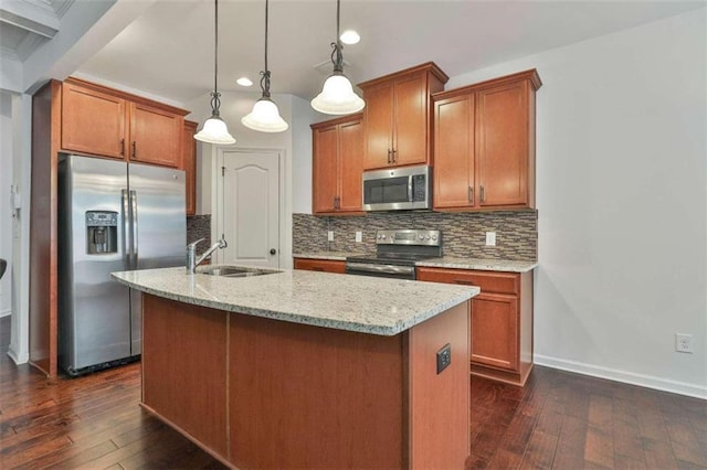 kitchen with a sink, tasteful backsplash, appliances with stainless steel finishes, and dark wood-style floors