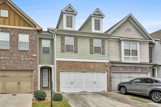 view of property featuring a garage, brick siding, board and batten siding, and driveway