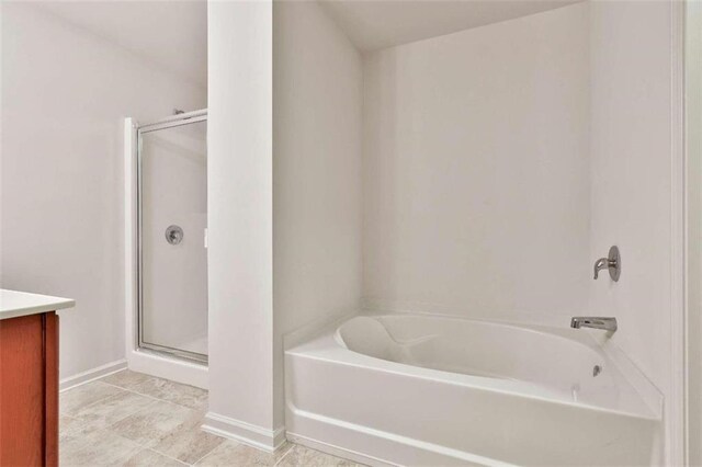 bathroom featuring tile patterned flooring, separate shower and tub, and vanity