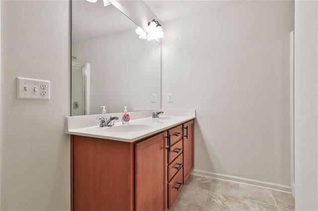 bathroom featuring a shower with door and vanity