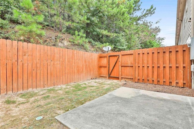 view of yard featuring a patio area and a fenced backyard