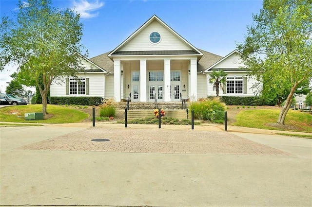 view of front of home with a front yard and a porch