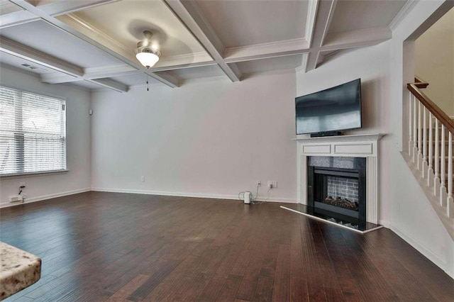 unfurnished living room featuring coffered ceiling, dark hardwood / wood-style floors, and beam ceiling